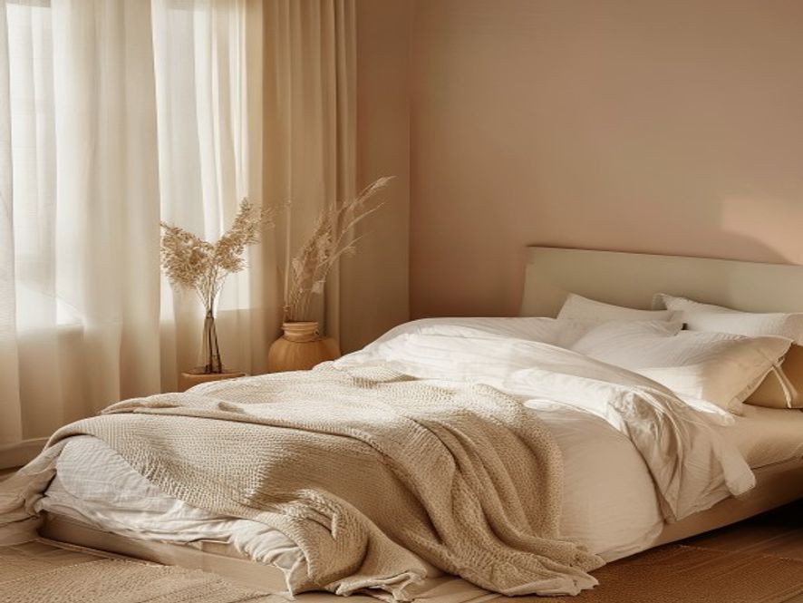 Minimalist bedroom with soft lighting, neutral tones, and comfortable bedding at dusk